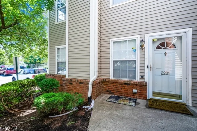 a backyard of a house with outdoor seating and plants
