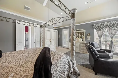 a bedroom with a bed couch and a window