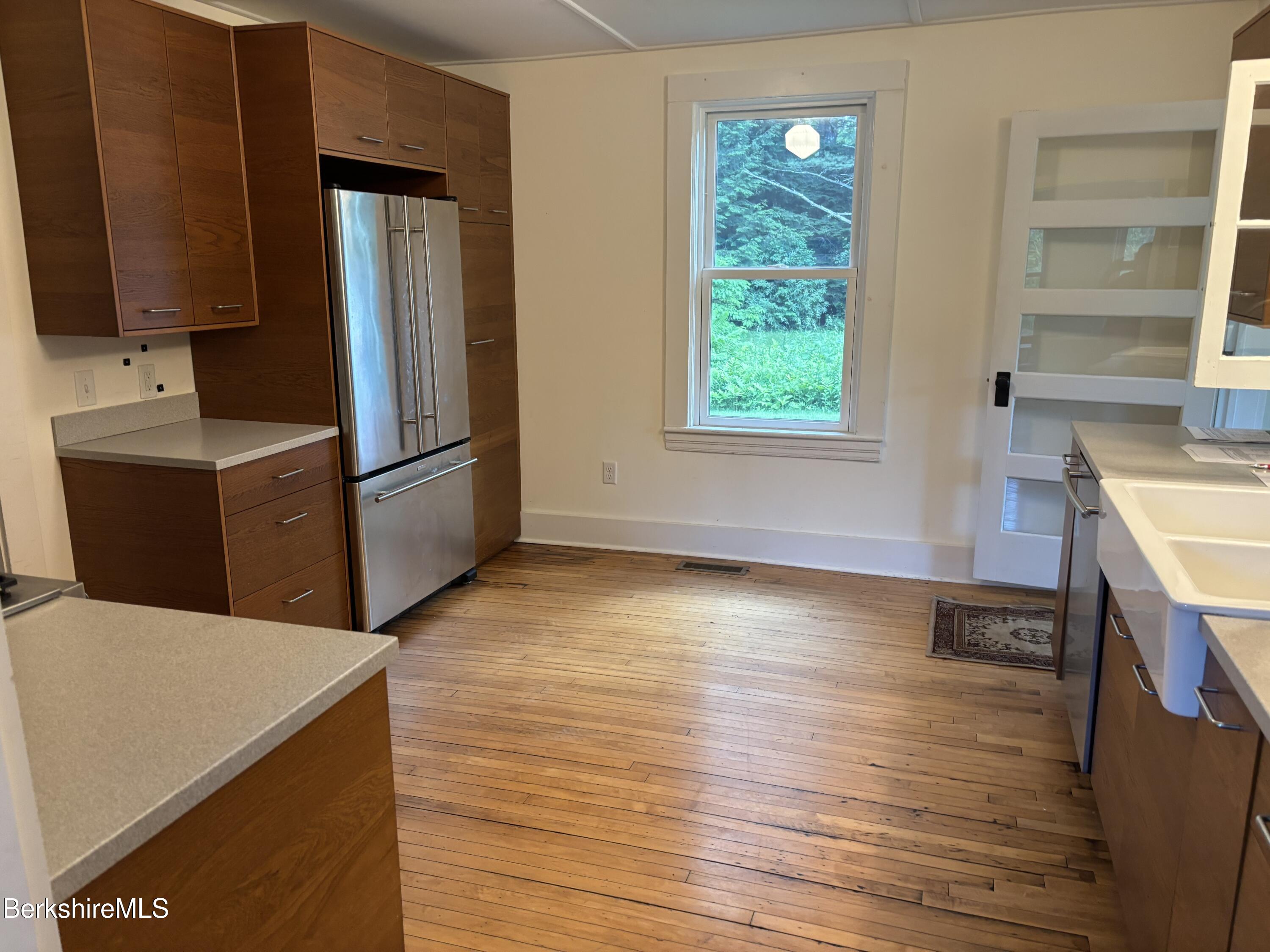 86 Miner Road Lanesborough, MA 01237 - Photo 41 of 44 a kitchen with stainless steel appliances granite countertop a refrigerator a stove and a wooden floors