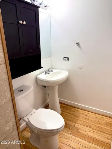 a bathroom with a sink toilet and mirror