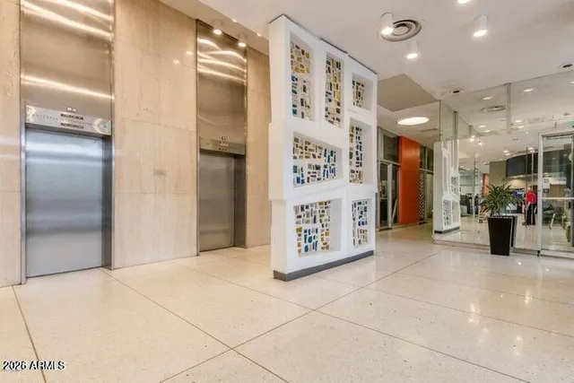 a kitchen with stainless steel appliances kitchen island granite countertop a refrigerator and a sink