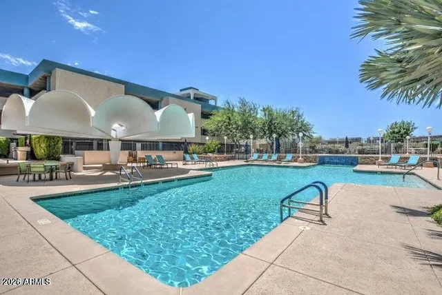 a swimming pool with outdoor seating and yard