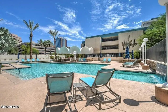 a swimming pool with outdoor seating and yard