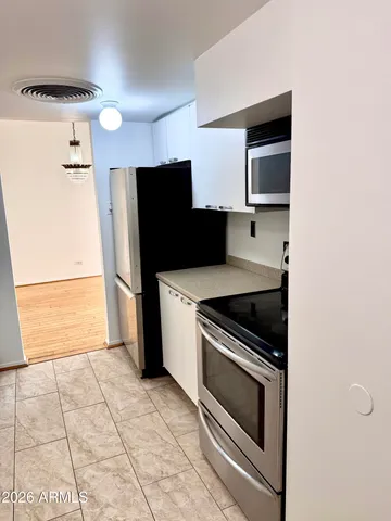 a kitchen with a stove and a refrigerator