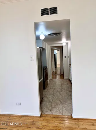 a view of a hallway with wooden floor