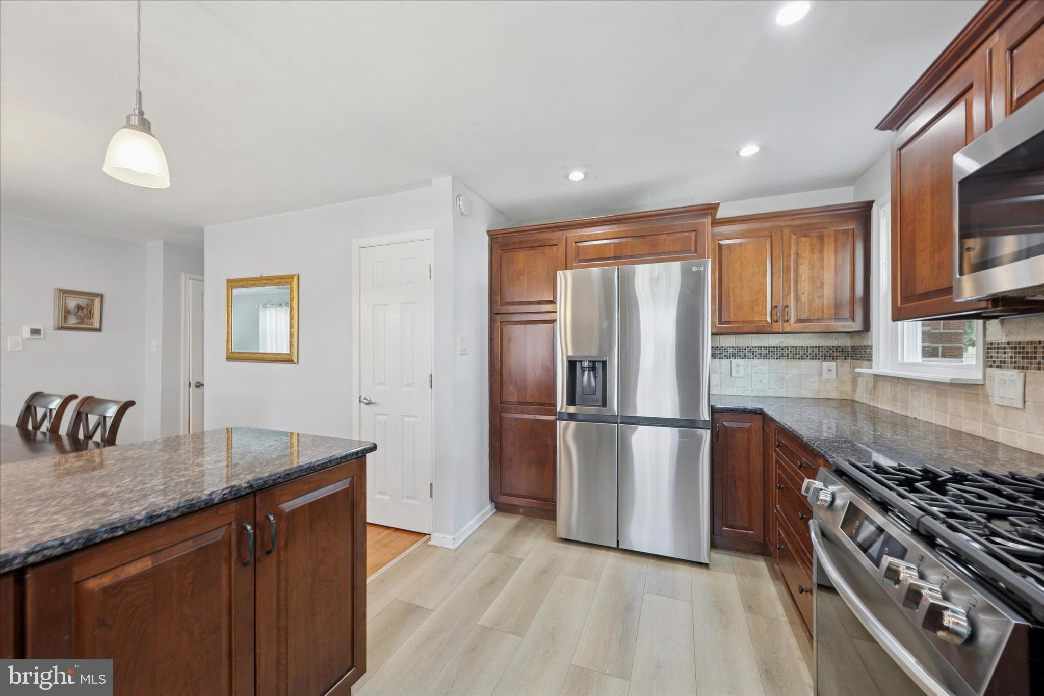 401 Haverford Road Folsom, PA 19033 - Photo 13 of 26 a kitchen with granite countertop a refrigerator stove top oven and sink