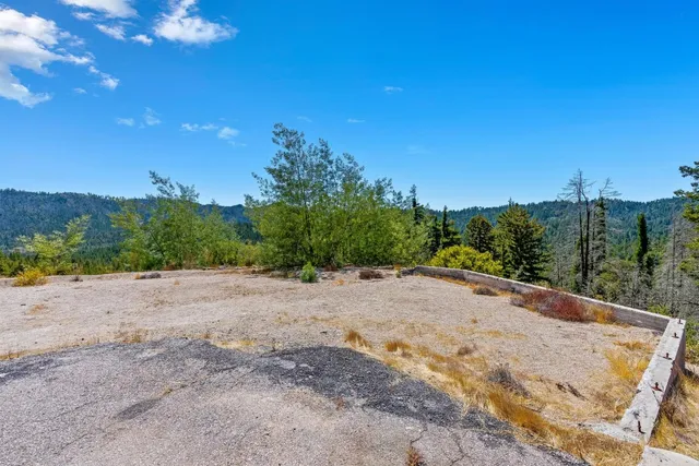 a view of a road with a house in the background