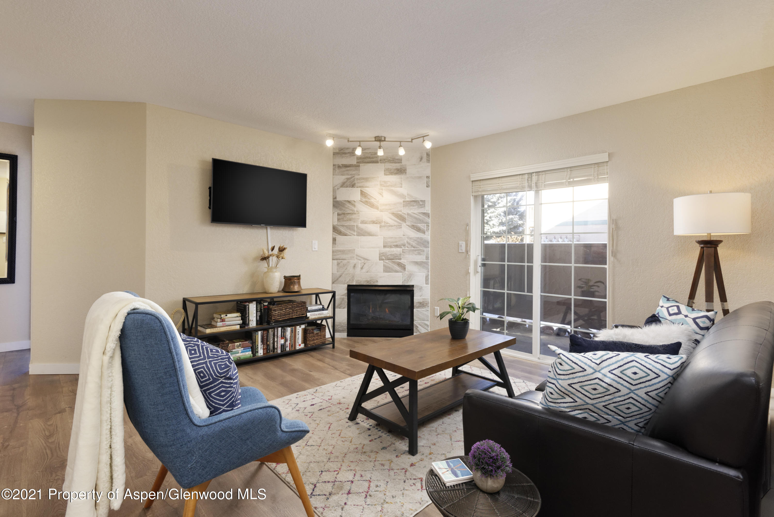 a living room with furniture a fireplace and a flat screen tv