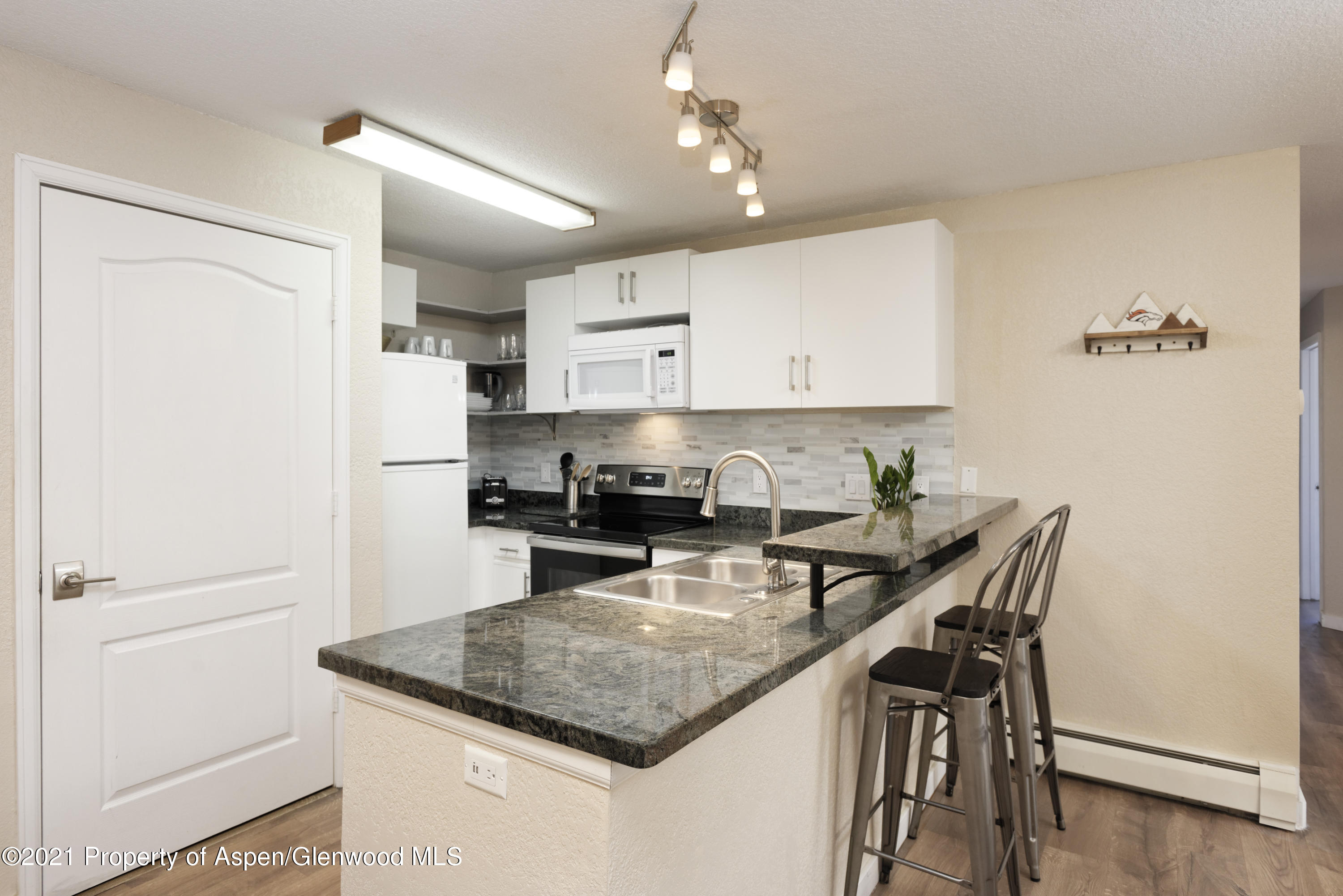 8104 Elk Lane Basalt, CO 81621 - Photo 5 of 13 a kitchen with a refrigerator a stove a sink and a refrigerator