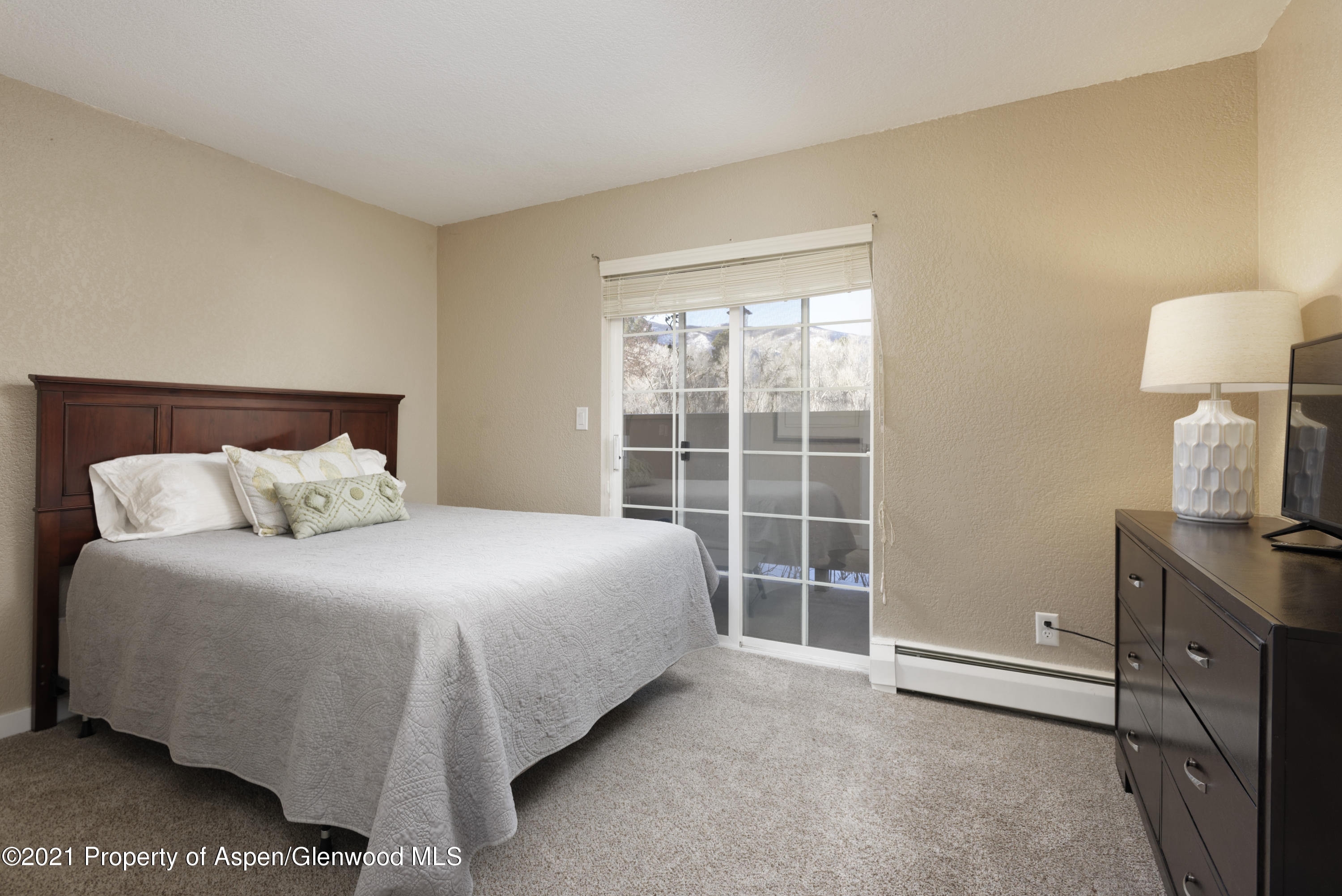 8104 Elk Lane Basalt, CO 81621 - Photo 10 of 13 a large bed sitting in a bedroom next to a window