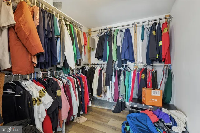 a bedroom with a bed a chandelier and a window