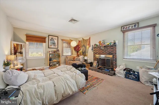 a living room with a bed furniture and a window