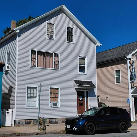 a front view of a house with parking space