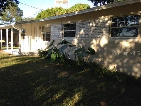 a backyard of a house with table and chairs