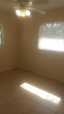 a view of a storage and utility room with refrigerator