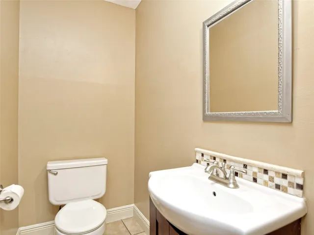 a white toilet sitting next to a white sink