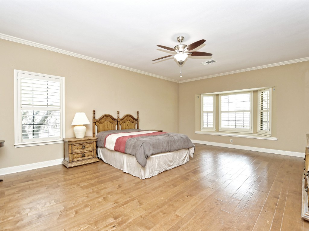 328 Fawnridge Street Georgetown, TX 78628 - Photo 16 of 36 a spacious bedroom with a bed cabinet and window
