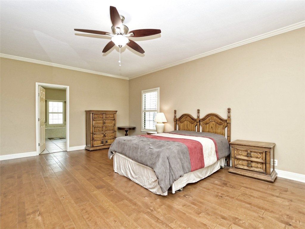 328 Fawnridge Street Georgetown, TX 78628 - Photo 17 of 36 a spacious bedroom with a bed and a ceiling fan