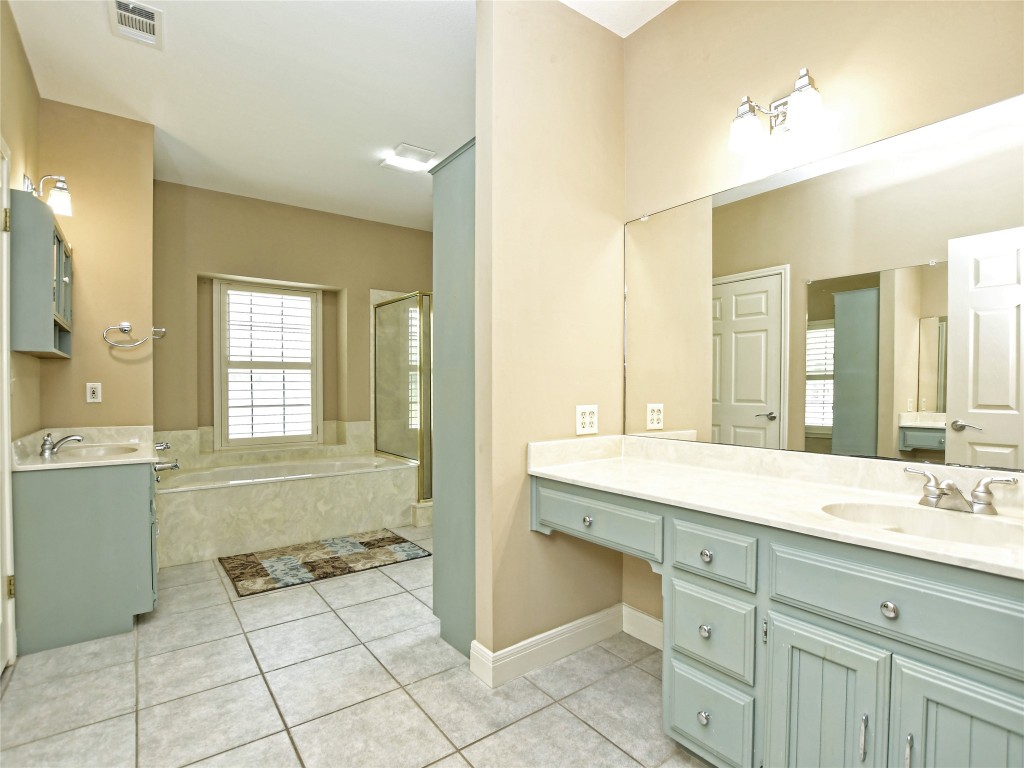 328 Fawnridge Street Georgetown, TX 78628 - Photo 19 of 36 a spacious bathroom with a granite countertop sink a mirror and a bathtub