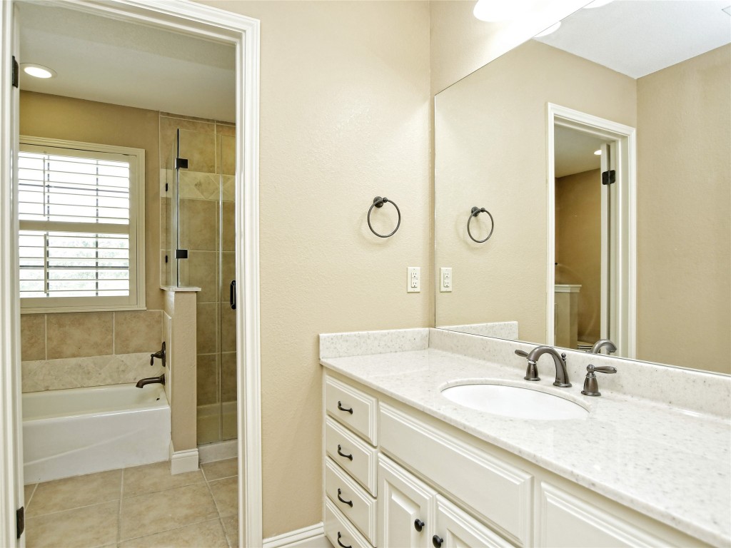 328 Fawnridge Street Georgetown, TX 78628 - Photo 24 of 36 a bathroom with a granite countertop sink a mirror and a bathtub