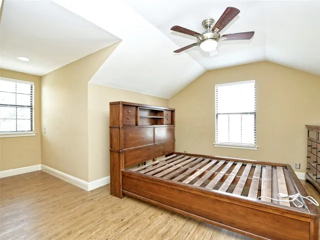 a living room with a bed and window
