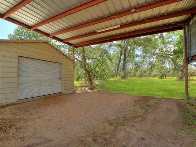 a view of a backyard with wooden fence