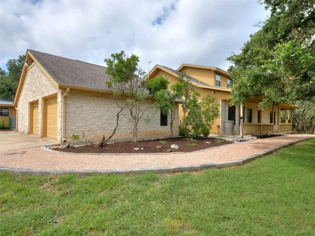 a backyard of a house with table and chairs