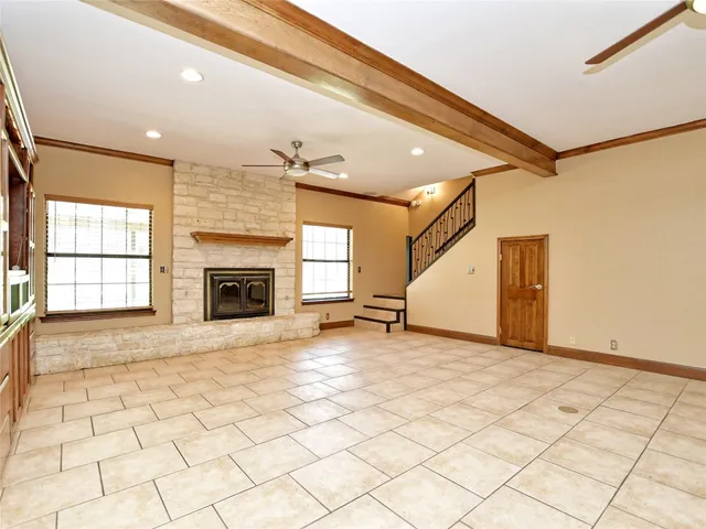 a view of an empty room and a fireplace