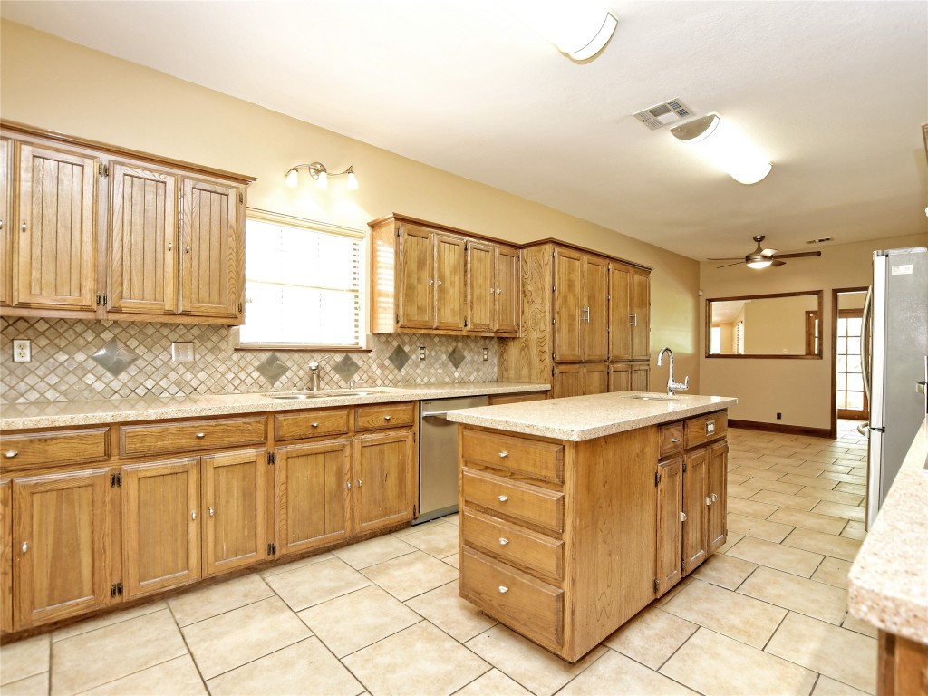 328 Fawnridge Street Georgetown, TX 78628 - Photo 10 of 36 a kitchen with granite countertop a sink and white cabinets