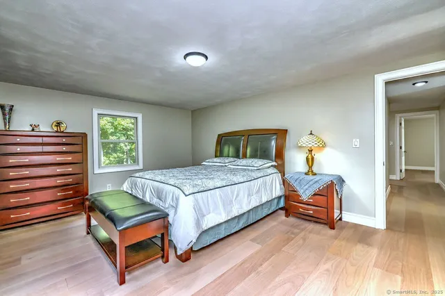 a bedroom with a bed and window