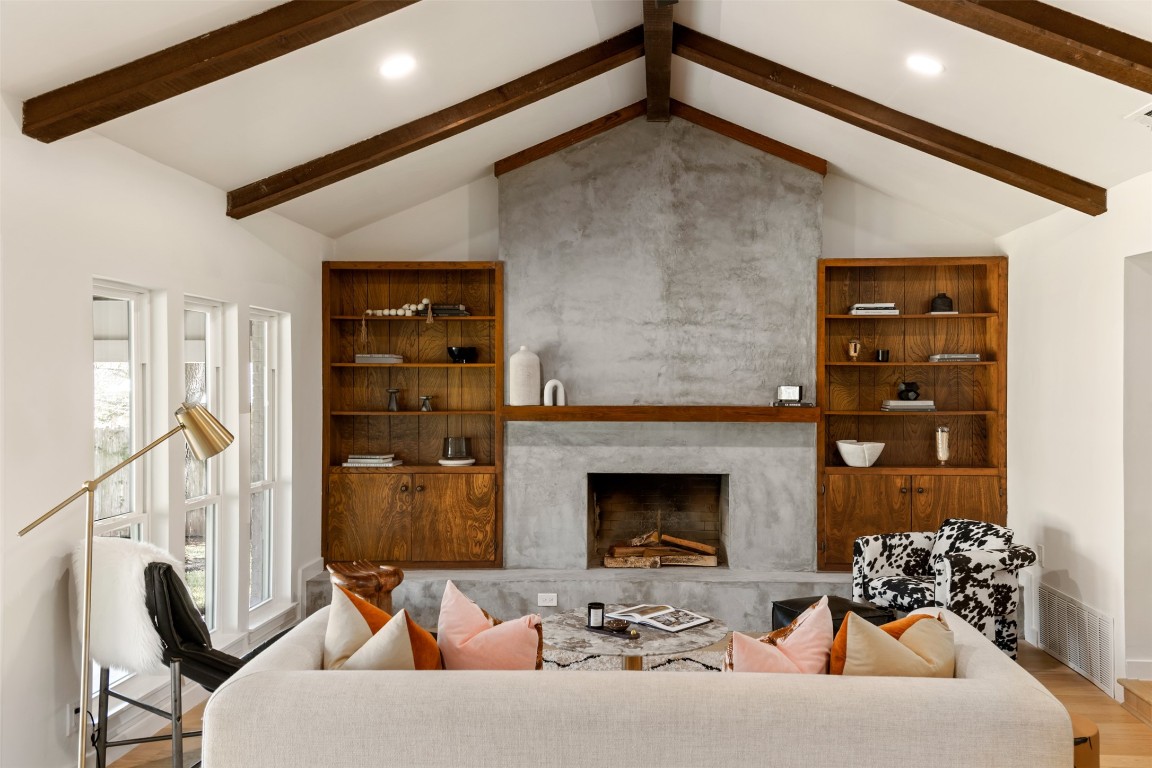 a living room with furniture and a fireplace