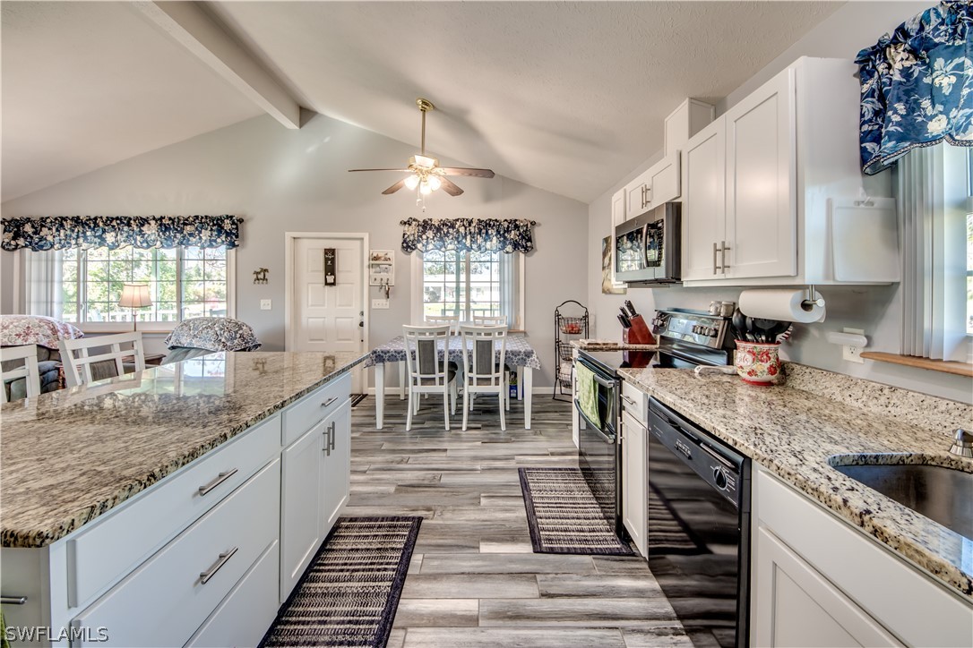 a large kitchen with granite countertop lots of counter top space