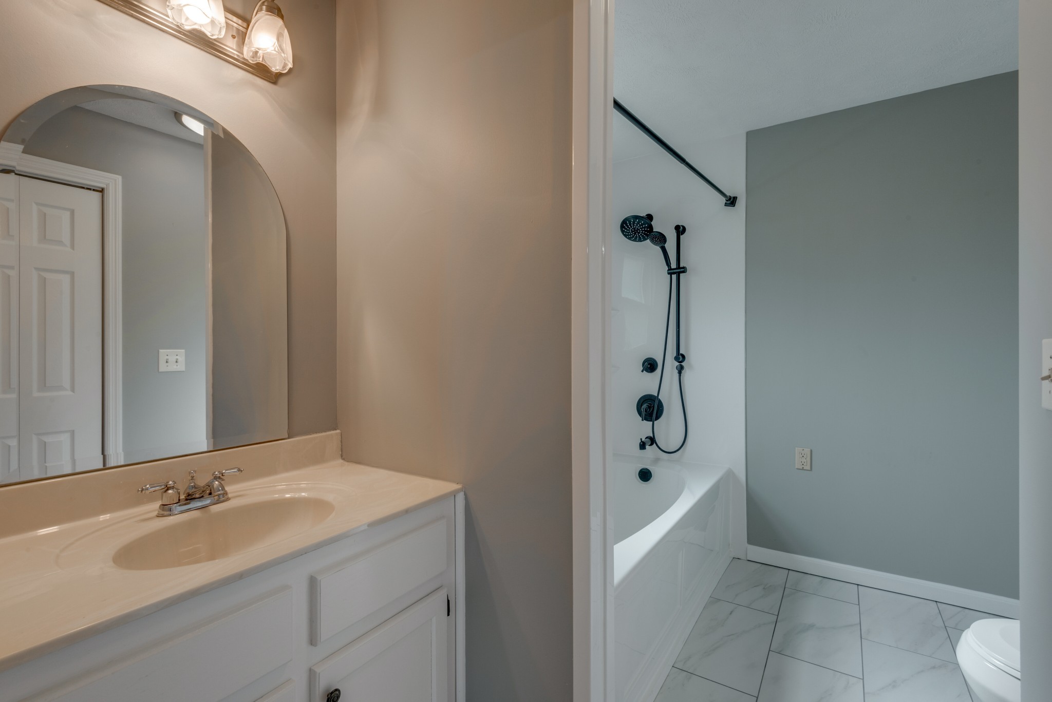 146 Howard Road White Bluff, TN 37187 - Photo 16 of 25 a bathroom with a bathtub a sink and a mirror