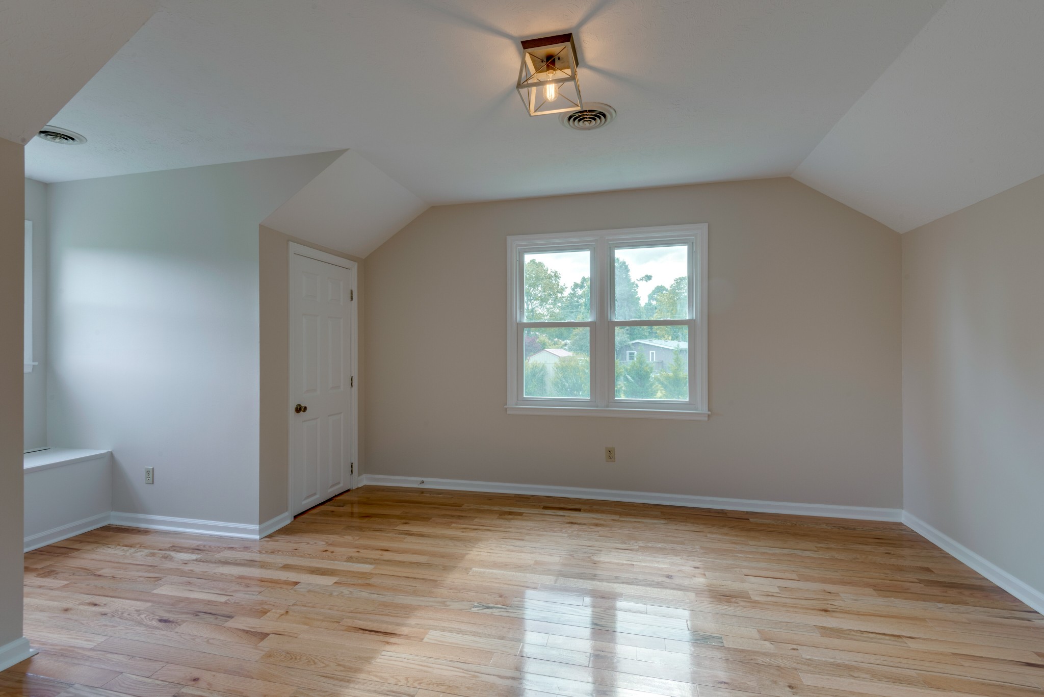 146 Howard Road White Bluff, TN 37187 - Photo 22 of 25 an empty room with wooden floor and windows