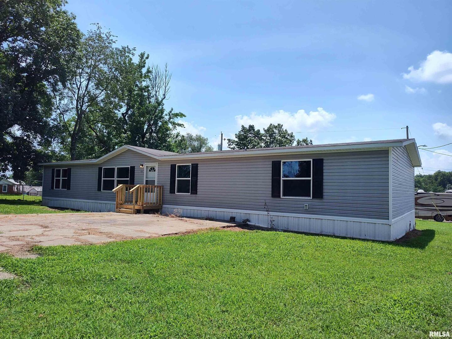531 Cemetery Road Grayville, IL 62844 - Photo 1 of 18 a front view of a house with a garden and trees