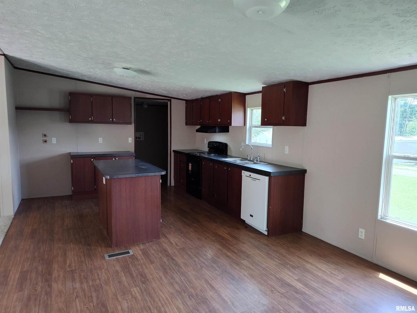 531 Cemetery Road Grayville, IL 62844 - Photo 6 of 18 a kitchen with stainless steel appliances wooden cabinets a sink and a stove