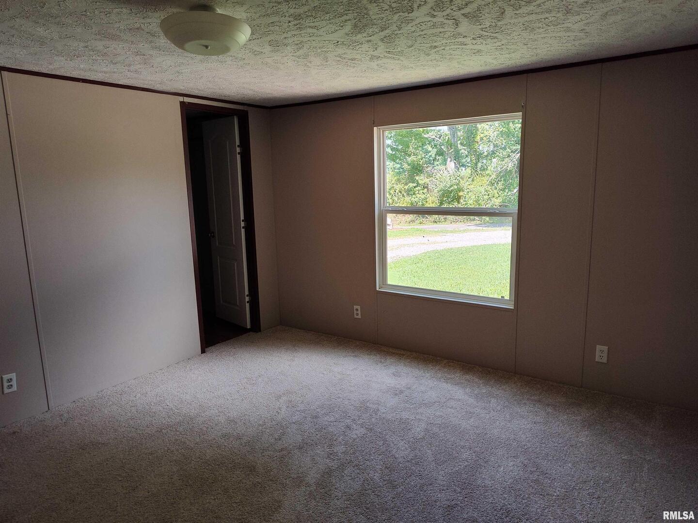 531 Cemetery Road Grayville, IL 62844 - Photo 10 of 18 an empty room with a window
