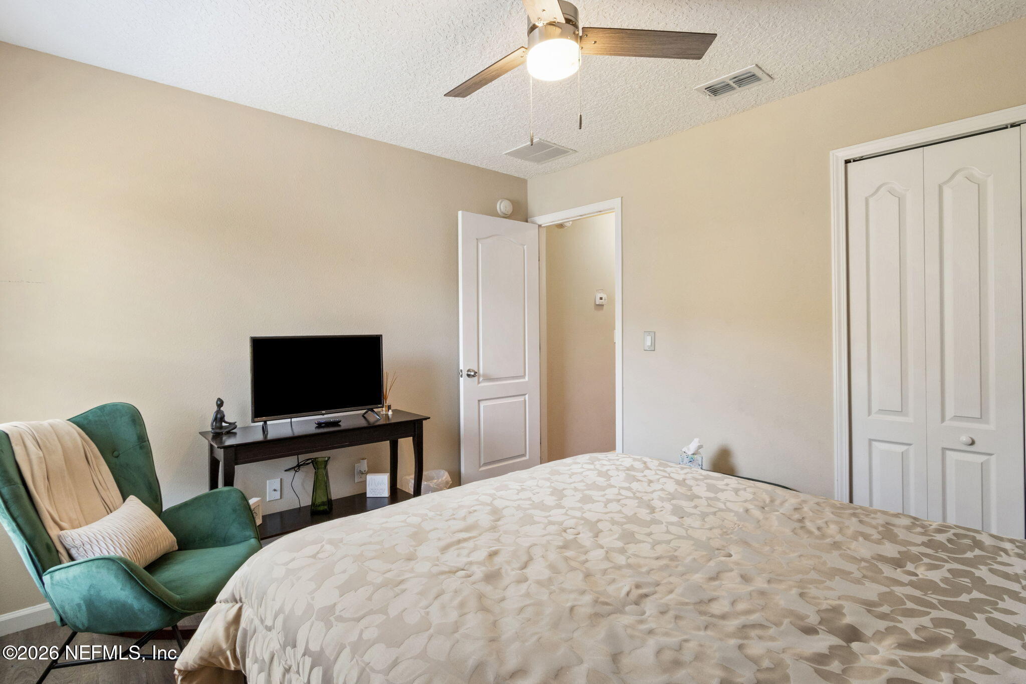 96034 Bass Lane Yulee, FL 32097 - Photo 39 of 50 a bedroom with a bed tv and chair