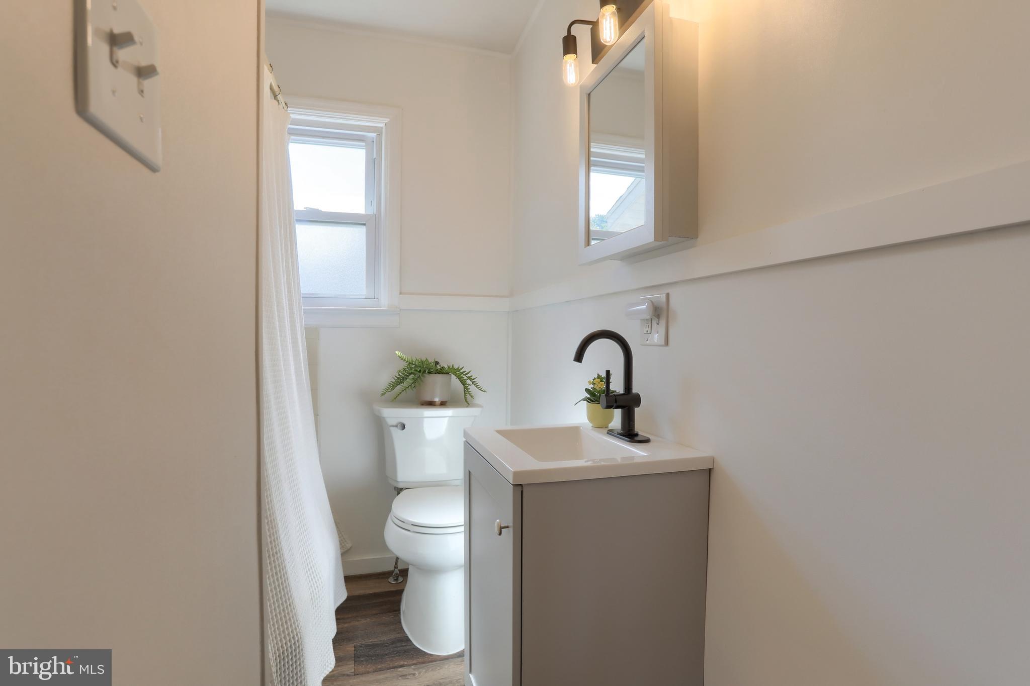 517 South 5th Street Lebanon, PA 17042 - Photo 17 of 29 a bathroom with a toilet sink and mirror