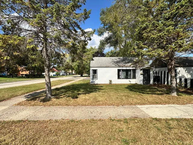 a view of a yard with a large tree