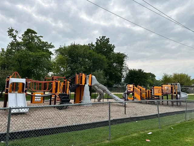 a view of park with swings and slides