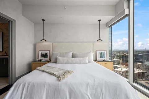 a bedroom with a bed and a chandelier