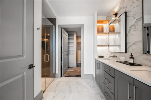 a bathroom with a double vanity sink and a mirror