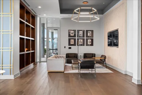a work room with furniture wooden floor and windows