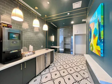 a view of a room with gym equipment and large windows