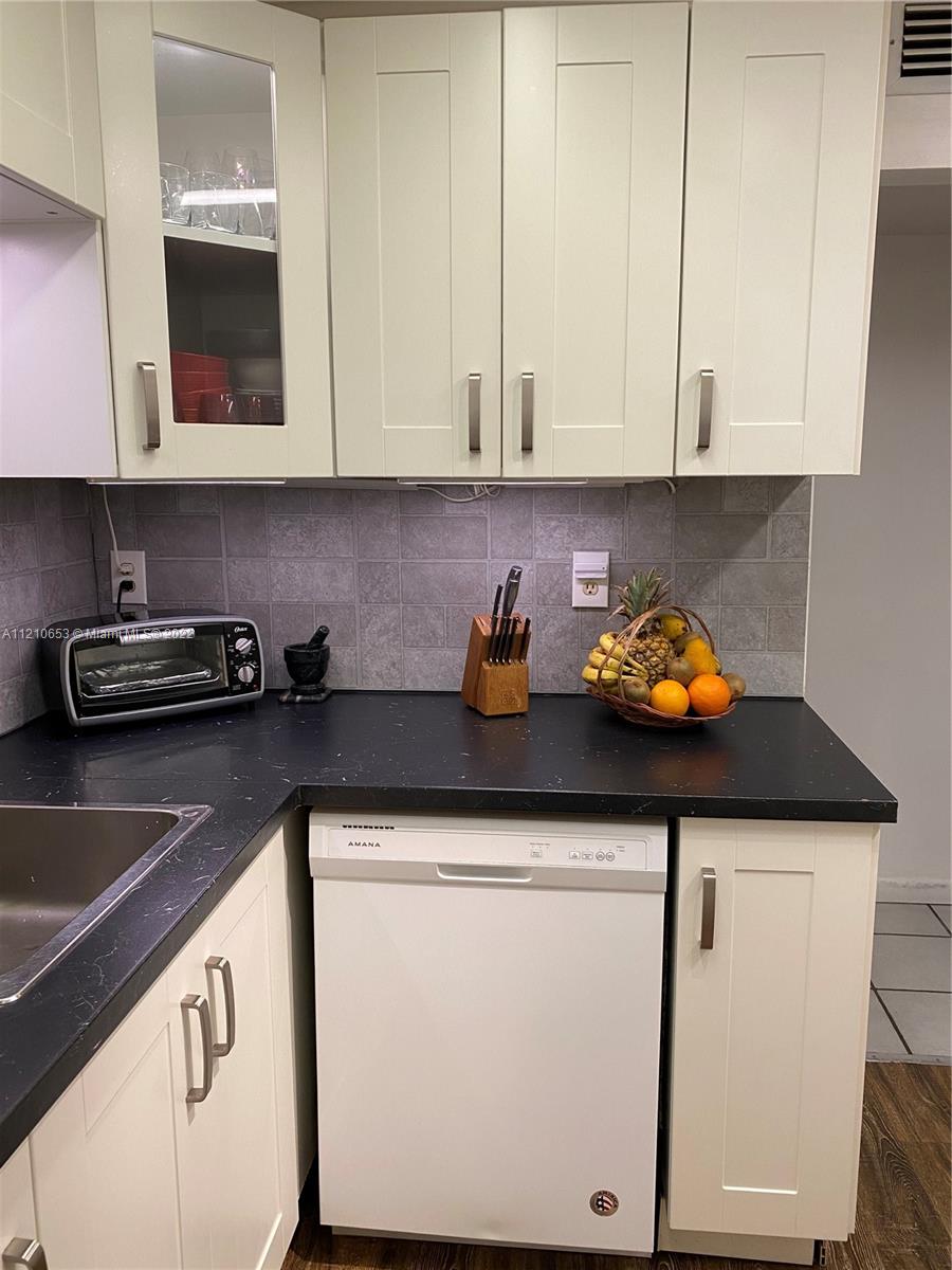 13700 Southwest 62nd Street, Unit 149 Miami, FL 33183 - Photo 12 of 36 a kitchen with stainless steel appliances white cabinets and a sink