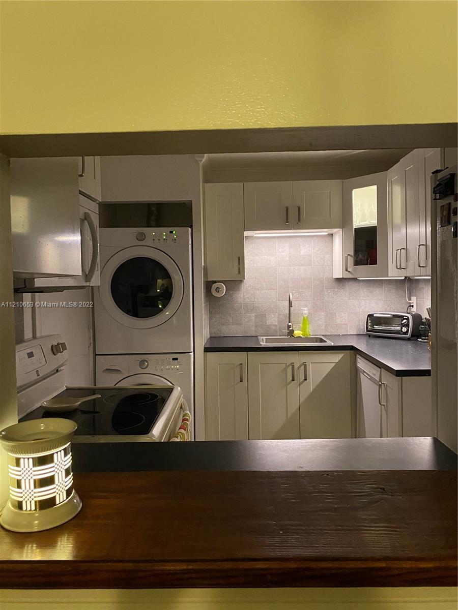 13700 Southwest 62nd Street, Unit 149 Miami, FL 33183 - Photo 15 of 36 a kitchen with a stove and a microwave