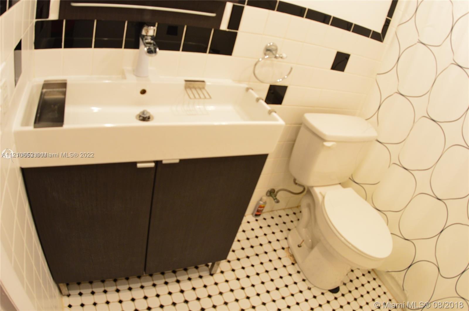 13700 Southwest 62nd Street, Unit 149 Miami, FL 33183 - Photo 18 of 36 a bathroom with a sink and a mirror