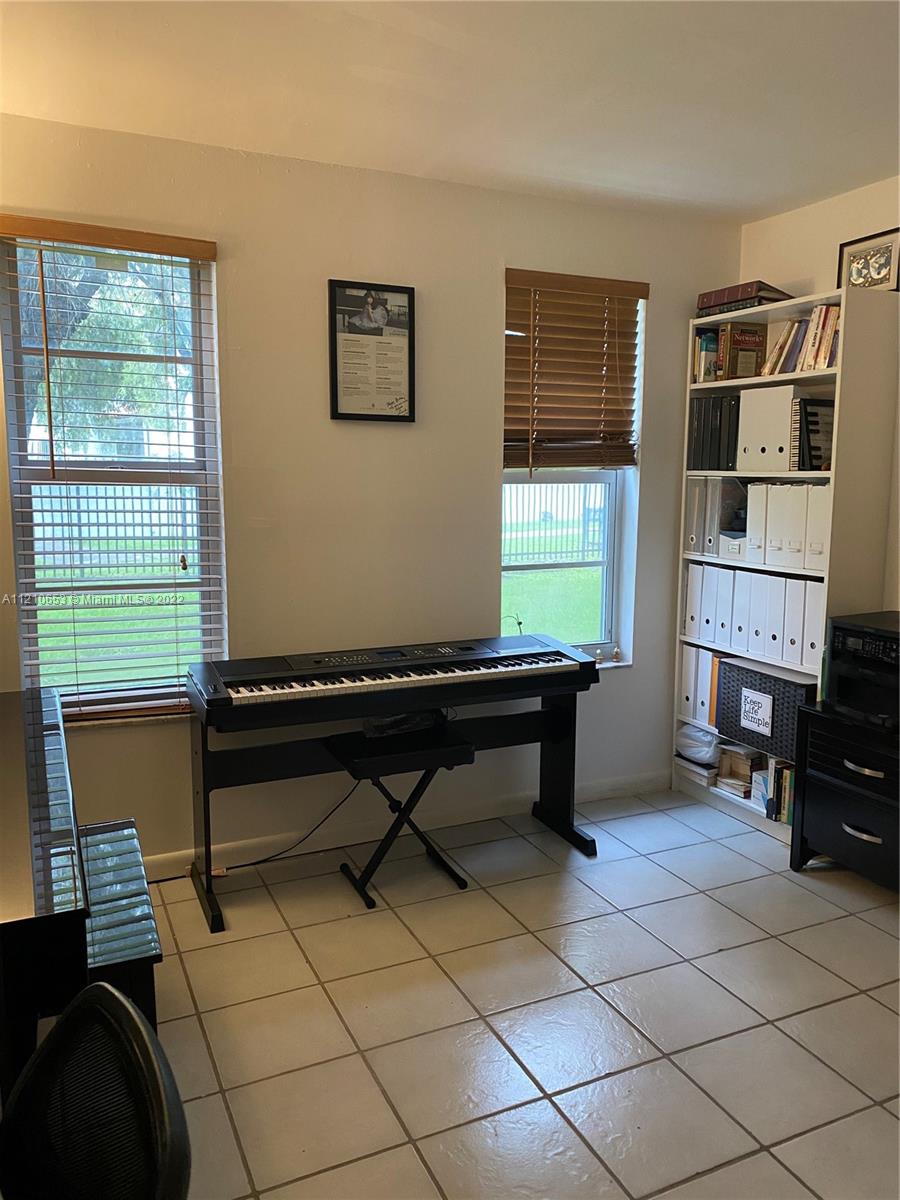 13700 Southwest 62nd Street, Unit 149 Miami, FL 33183 - Photo 21 of 36 a room with furniture a window and a flat screen tv