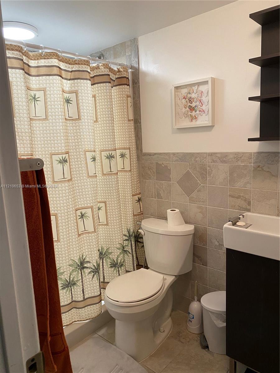 13700 Southwest 62nd Street, Unit 149 Miami, FL 33183 - Photo 26 of 36 a bathroom with a toilet a sink and shower